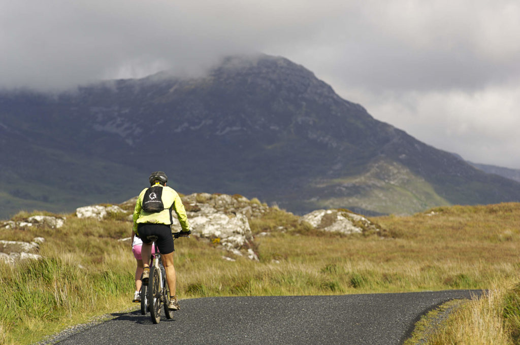 man cycling on a cliff