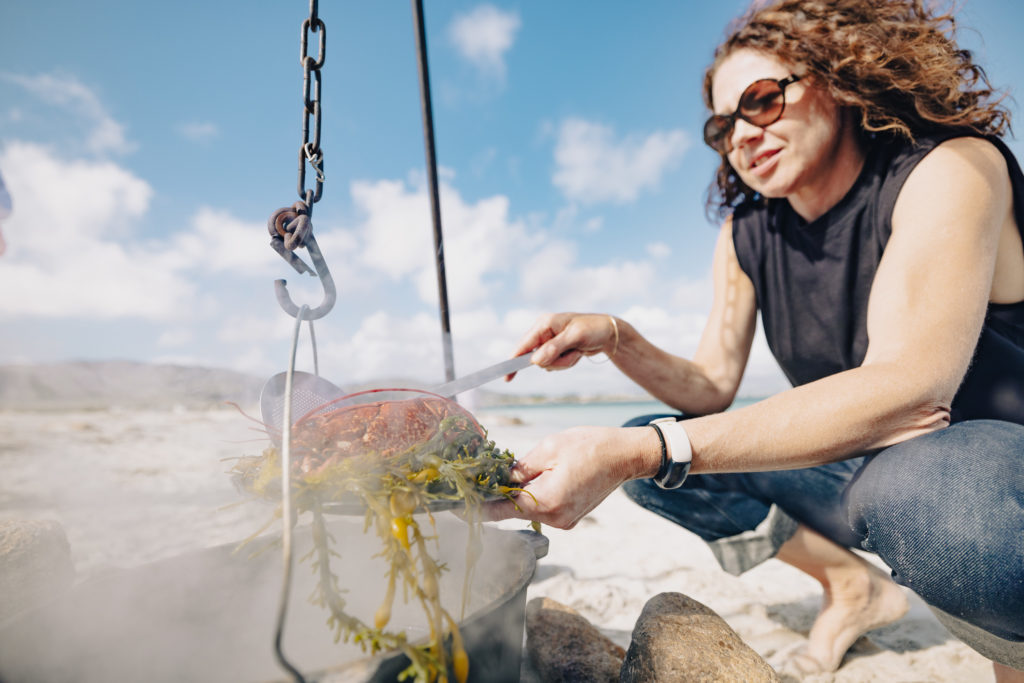 woman cooking on the beach